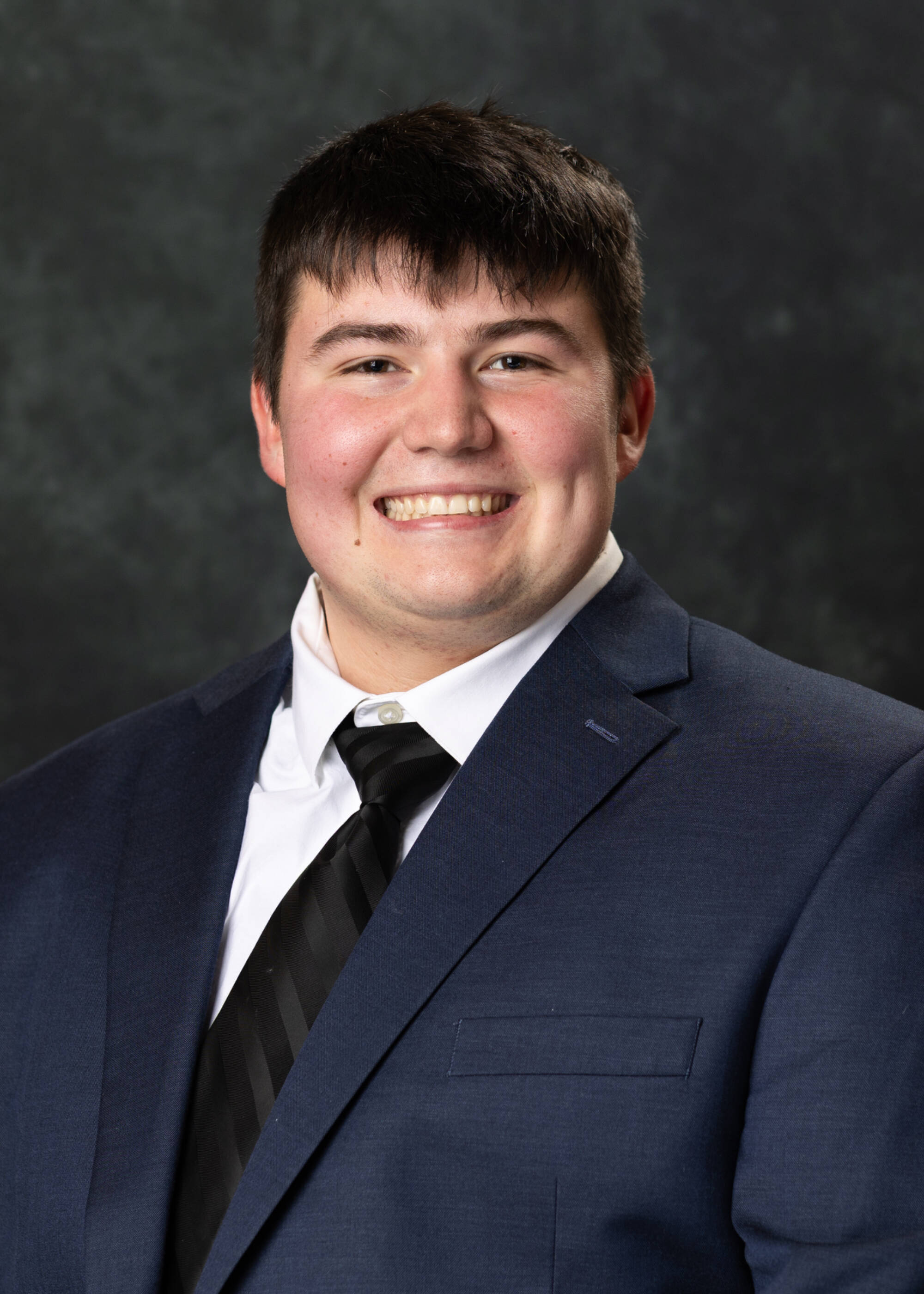 Samuel Schwallier smiling in a suit